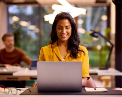 Woman smiling at her laptop